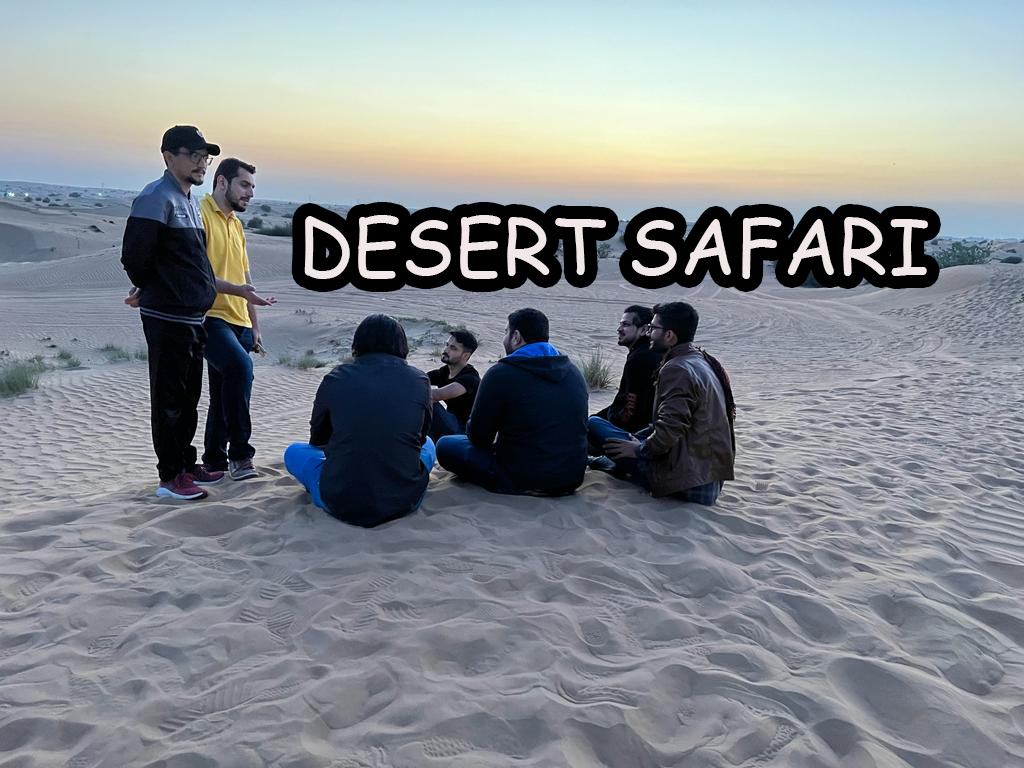 A group of people sitting in the sand Description automatically generated with medium confidence